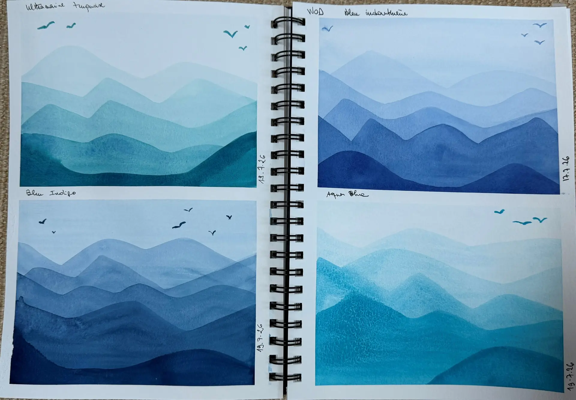 Student watercolour sketchbook of blue mountain ranges in four pigment studies