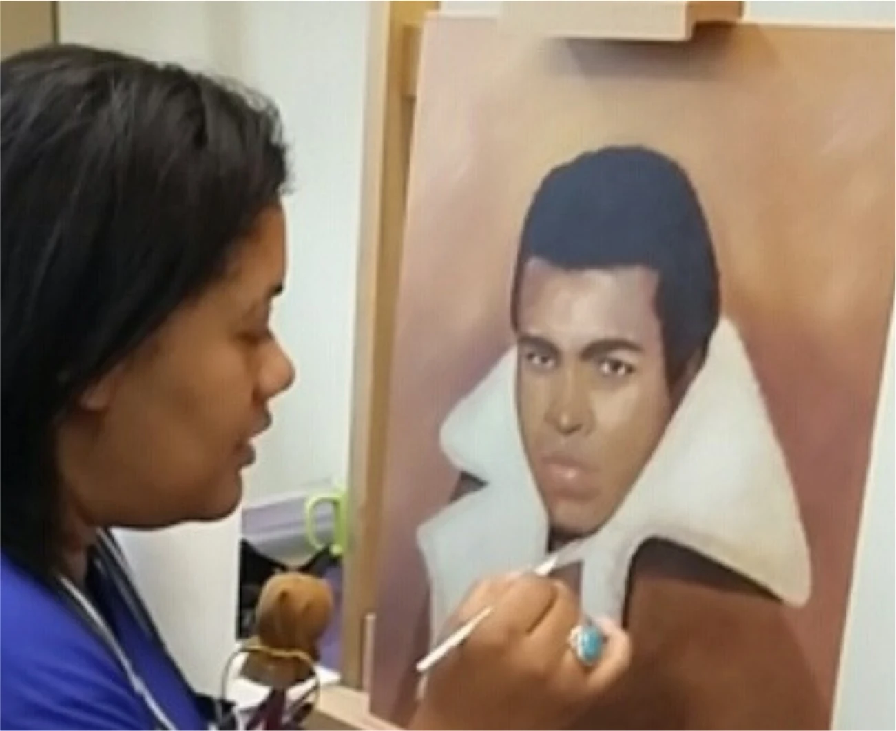 Anne-Marie painting a portrait of Muhammad Ali